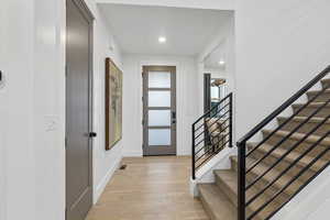 Entryway featuring light wood-type flooring and recessed lighting