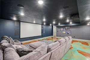 Home theater with a textured ceiling and recessed lighting
