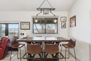 Dining area with light wood-style flooring