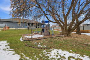 Snow covered house with a playground