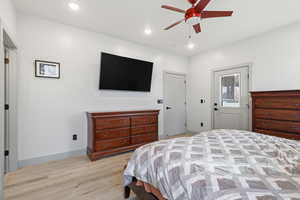 Master Bedroom featuring light wood-type flooring, ceiling fan, and recessed lighting and private entrance to back covered deck.