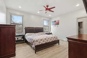 Master Bedroom with light wood-type flooring, ceiling fan, and recessed lighting