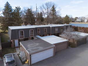 View of front of home featuring a jacuzzi, a residential view, a garage, and a chimney