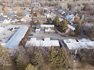 Aerial view of property and surrounding area featuring nearby suburban area