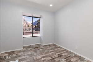 Spare room featuring a mountain view and light wood-style floors