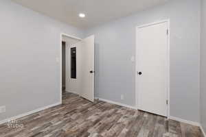 Unfurnished room with baseboards and light wood-style flooring