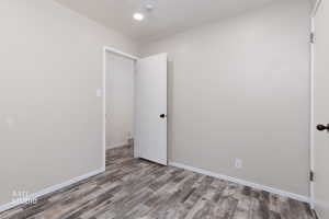 Unfurnished room with baseboards and wood finished floors