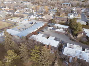 Aerial view of property and surrounding area with nearby suburban area