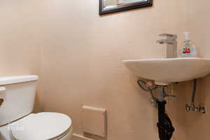 Half bathroom with toilet and a sink