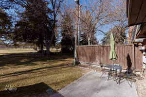 View of yard with a patio and outdoor dining space