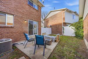 Fenced backyard featuring an outdoor fire pit and a patio area