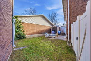 Fenced backyard with a shed and a patio