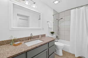 Bathroom with vanity and shower / tub combo with curtain