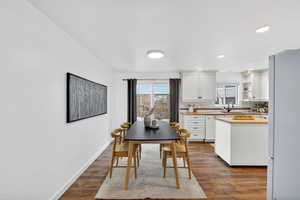 Dining room featuring dark wood-type flooring and recessed lighting