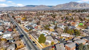 Aerial overview of property's location with a mountain backdrop and nearby suburban area