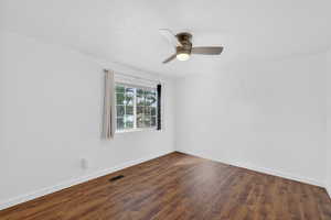 Bedroom 2 with LVP wood flooring and ceiling fan
