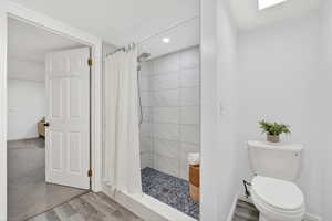Laundry Room & Bathroom featuring a shower stall, wood finished floors, and recessed lighting