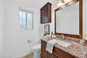 Half bath featuring vanity and light tile patterned floors