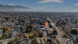 Aerial view of property's location featuring mountains and nearby suburban area