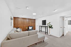 Basement Family Room featuring baseboards and light colored carpet