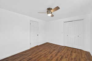 Bedroom 2 featuring a closet, a ceiling fan, and dark wood-style floors
