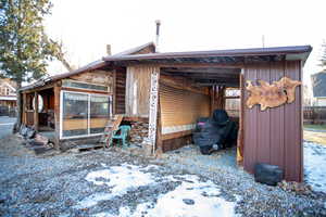 Snow covered property featuring a sunroom