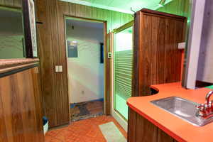 Bathroom featuring vanity and wood walls
