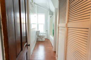 Hallway featuring light wood-type flooring and baseboards