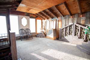Sitting room with lofted ceiling and carpet floors