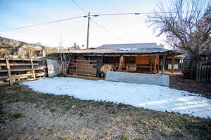 Snow covered structure featuring an exterior structure