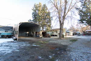 View of side of property with a carport and driveway