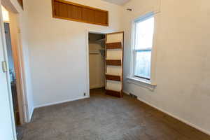 Unfurnished bedroom featuring a closet and carpet flooring
