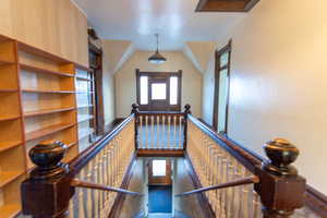 Staircase featuring plenty of natural light and carpet floors