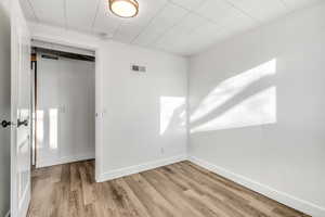 Spare room featuring wood finished floors