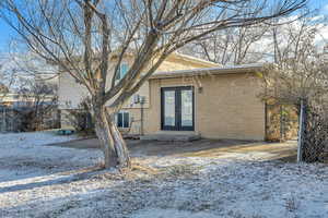 View of front of home featuring french doors and brick siding