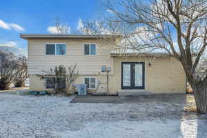 Back of house featuring french doors and brick siding