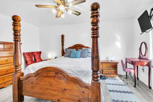Bedroom featuring wood finished floors and a ceiling fan