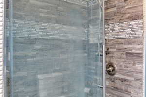 Full bathroom featuring a shower stall