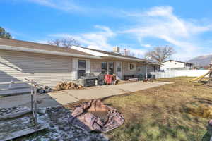 Back of property featuring a patio area and roof with shingles