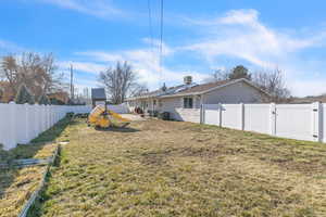 Fenced backyard with a gate and a patio