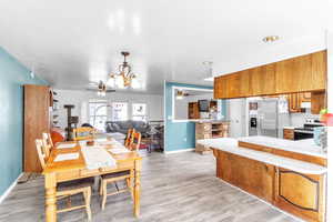 Dining room with light wood-style floors and a ceiling fan