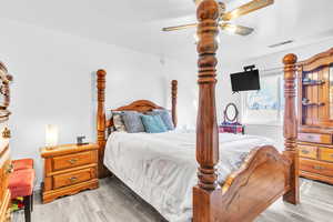 Bedroom featuring a ceiling fan and wood finished floors