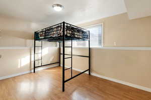 Unfurnished bedroom with light wood finished floors and a textured ceiling