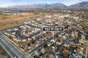 Aerial overview of property's location with nearby suburban area and a mountainous background