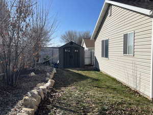 Fenced backyard with a storage shed