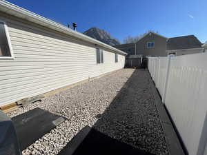 View of side of home with a fenced backyard