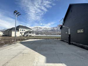 Sport court next to detached garage at back of lot. Exterior space with a mountain view