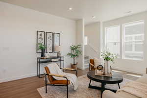 Sitting room with wood finished floors and recessed lighting