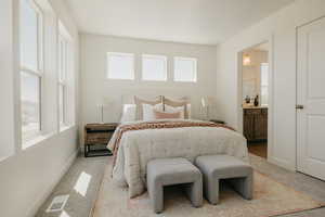 Bedroom with carpet floors and ensuite bathroom
