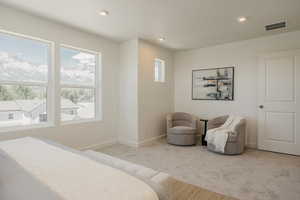 Bedroom featuring carpet flooring, recessed lighting, and a mountain view